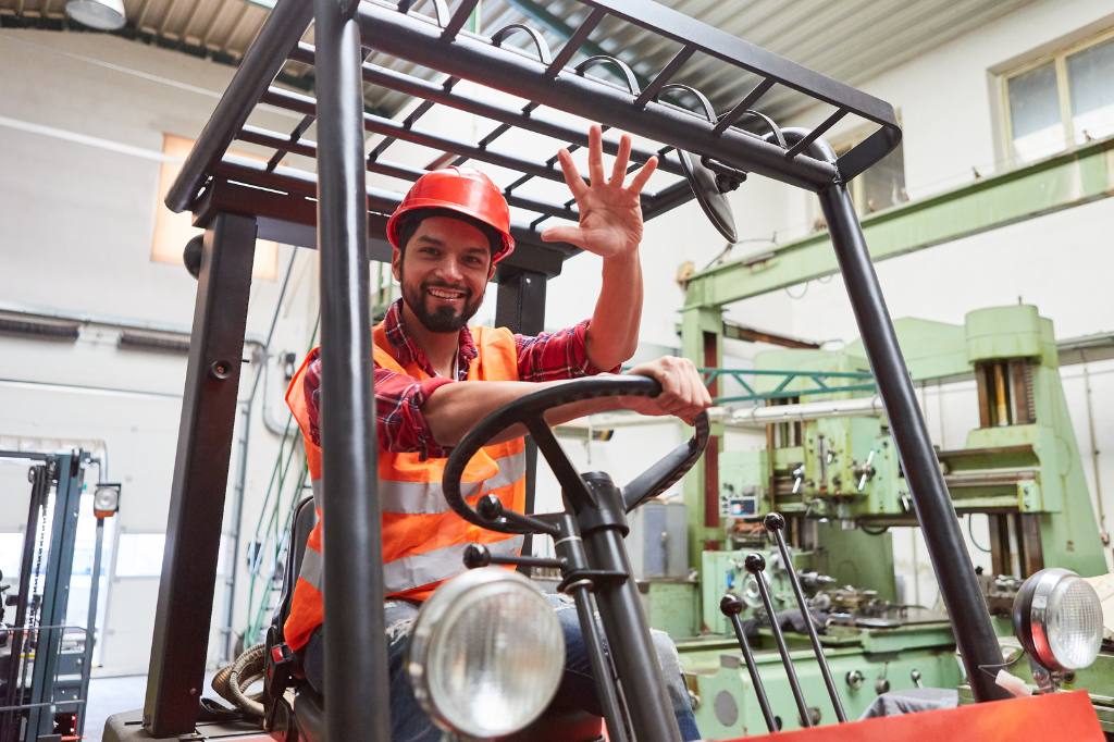 forklift operator smiling and waving