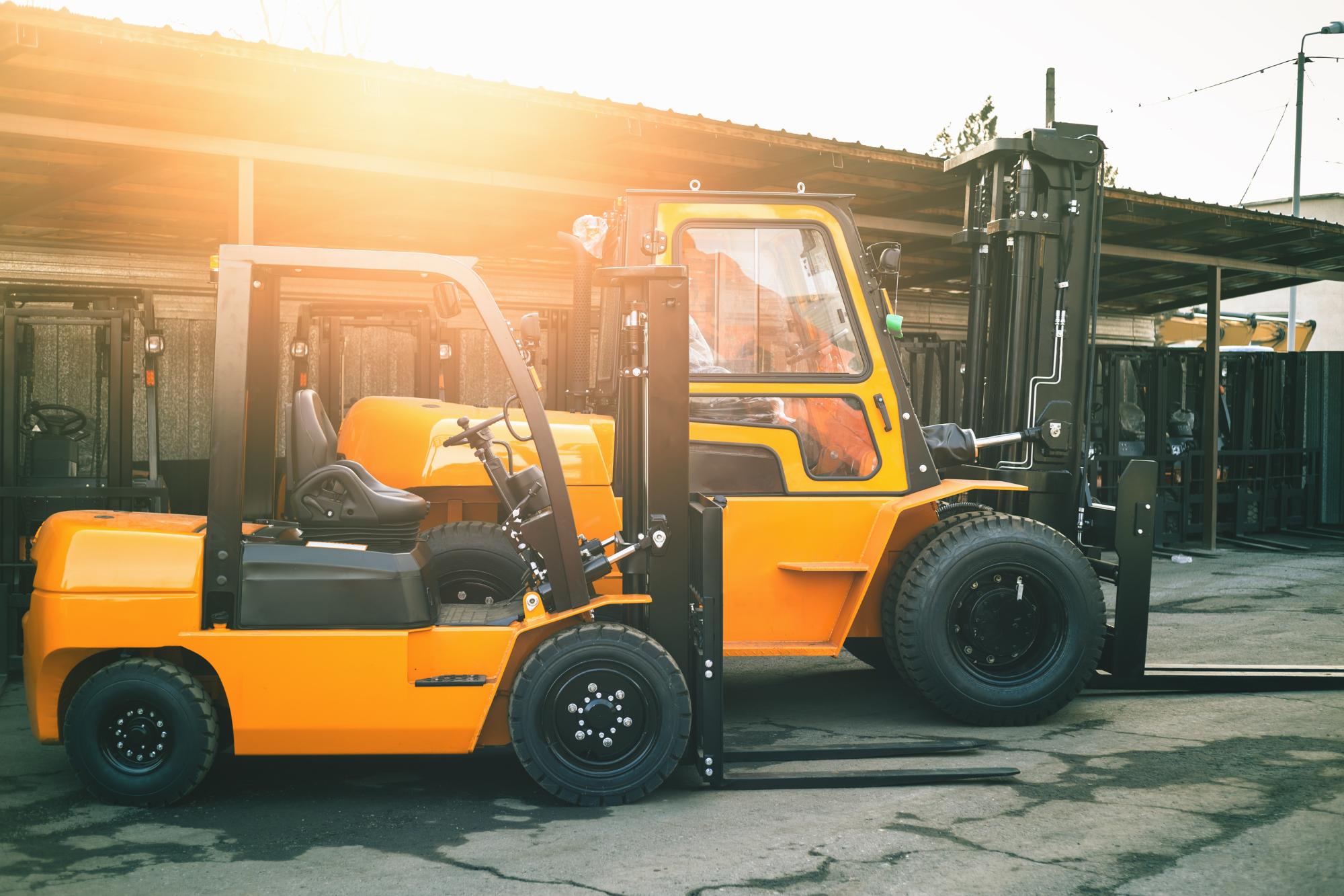 two forklifts side by side