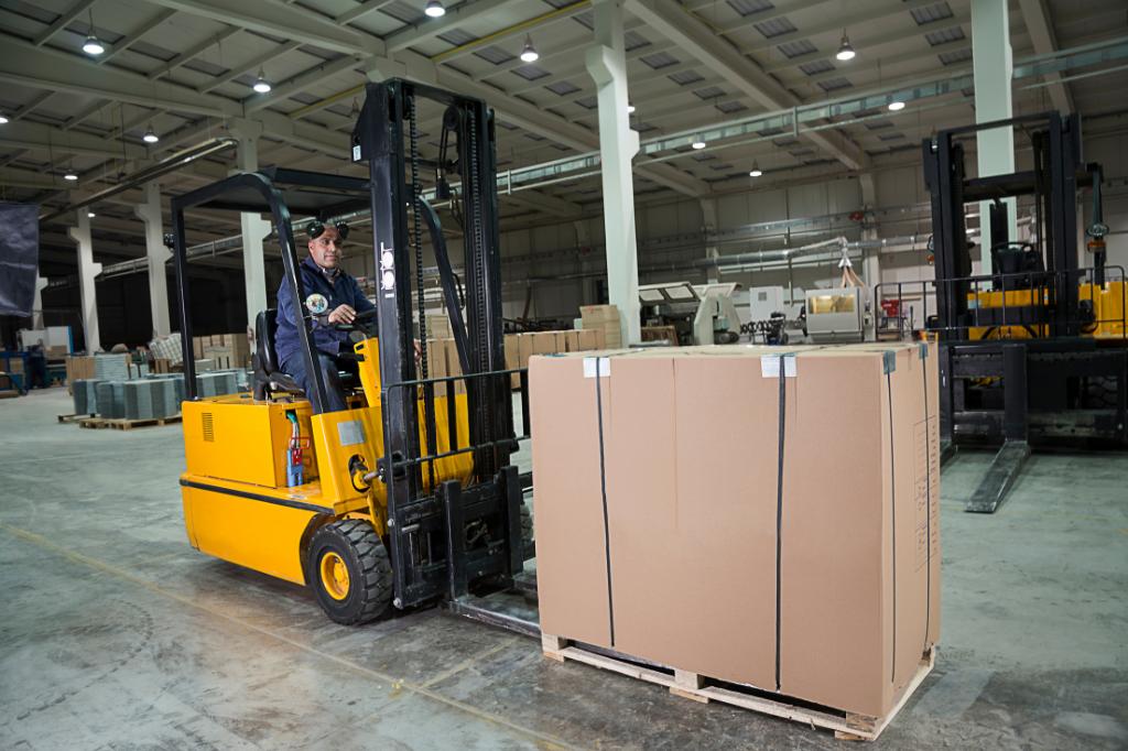 yellow forklift lifting box