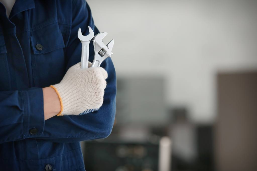 repair man holding wrenches