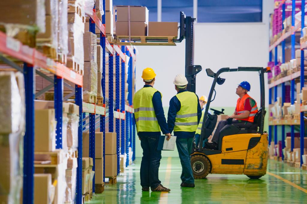 two men in front of forklift