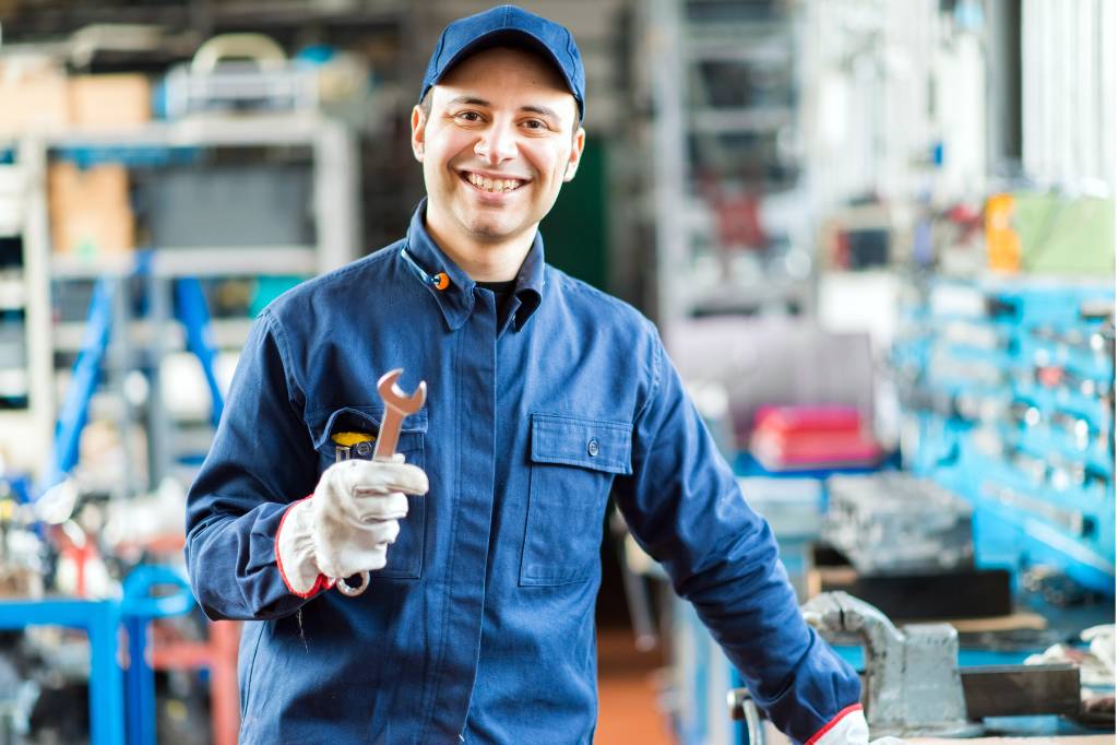 machanic smiling with wrench